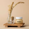 Glow Rice Cream with rice bran water and vitamin C, displayed with dried flowers and rice grains on a wooden tray.