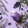 Frudia Blueberry Hydrating Cream Jar on purple background with blueberries