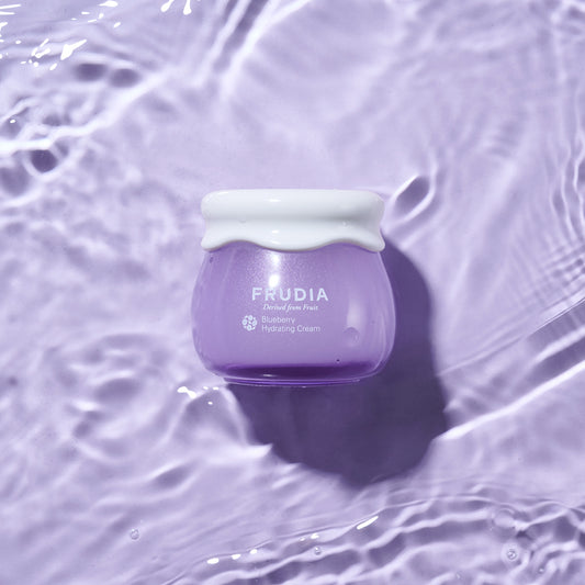 Frudia Blueberry Hydrating Cream Jar on purple background 